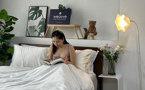 Beatrice sitting on bed with Weavve Home’s TENCEL™ Sheets