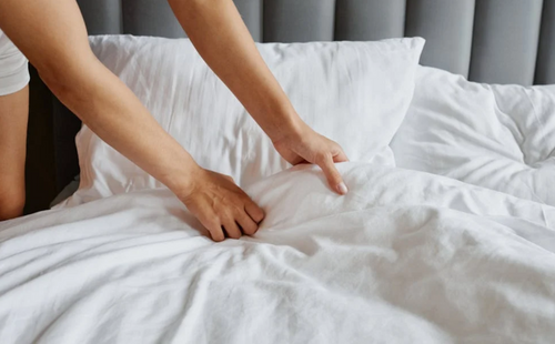 a person touching a gray cover