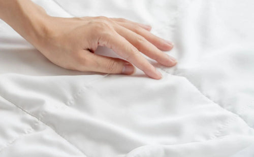 Hand touching Weavve's Lyocell Duvet close up texture