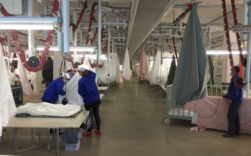 An image of workers working in a bedding factory