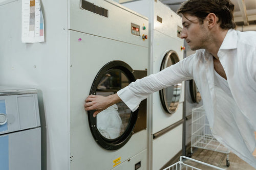 Man washing the weighted blanket using a washing machine