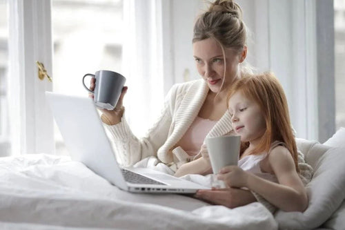 Woman and kid on bed with hypoallergenic sheets