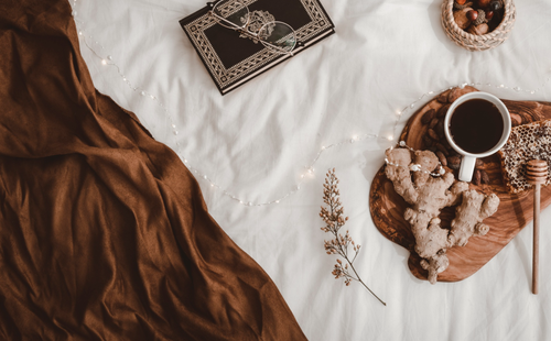 a mocha duvet near book and glasses
