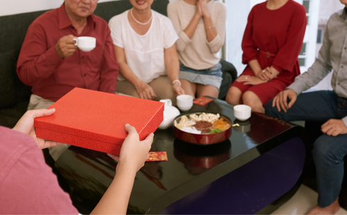 a person giving present to family