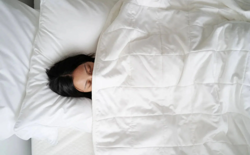girl sleeping with a white duvet
