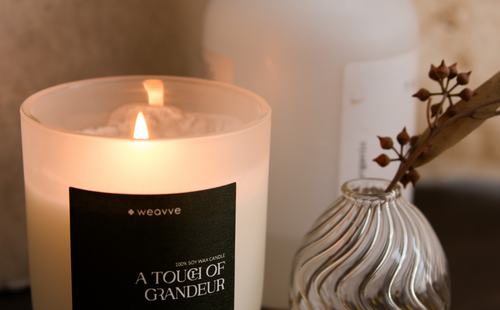 soy candle placed next to a vase