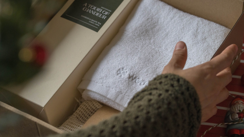 Closeup on someone preparing a gift for colleagues wrapped in a box