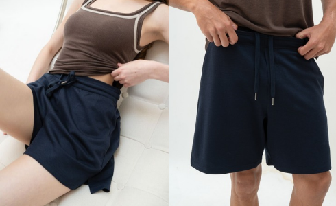 A split-panel photo showing navy drawstring shorts worn by a model. The left panel shows a woman reclining and pulling the shorts up slightly to demonstrate fit.