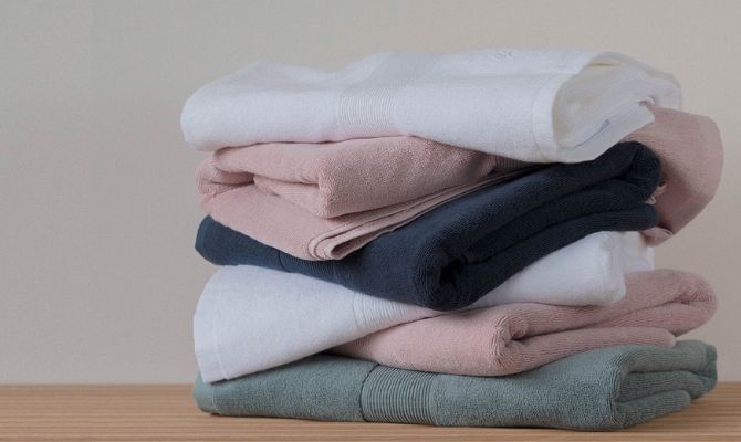 stacked silver infused cotton towels in different colours