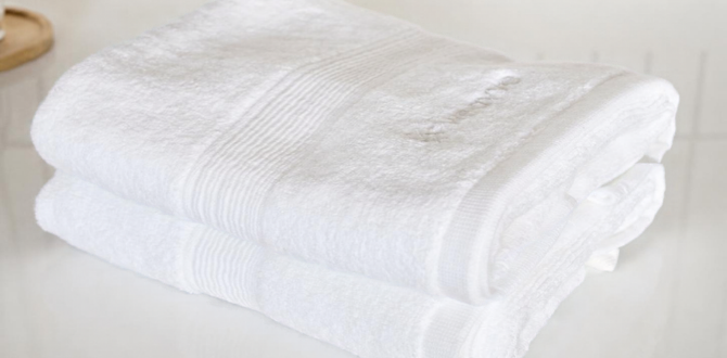 white face towels stacked on the bathroom countertop